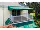 View of a second story balcony with green awning and white railing overlooking the landscaped property at 8356 Meadow Lakes Dr, Charlotte, NC 28210