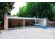 Open carport with a brick facade, featuring parking space and a neatly organized storage area at 8356 Meadow Lakes Dr, Charlotte, NC 28210