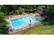 Aerial view of a large community pool with lounge chairs, tables, and landscaped surroundings at 8356 Meadow Lakes Dr, Charlotte, NC 28210