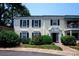 Inviting two-story condo with classic black shutters, well-maintained landscaping, and charming entryway at 8356 Meadow Lakes Dr, Charlotte, NC 28210