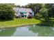 Rear exterior view of a multi-story home showcasing well-maintained lawn and landscaping at 8356 Meadow Lakes Dr, Charlotte, NC 28210