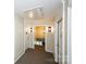 Hallway featuring doorways, neutral walls with trim, and sconce lighting at 8356 Meadow Lakes Dr, Charlotte, NC 28210
