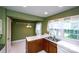 Kitchen features green walls, white tile floors, double sink, and a bright window at 8356 Meadow Lakes Dr, Charlotte, NC 28210