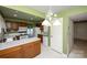 Open kitchen with wood cabinets, white appliances, island counter, and view to a lake at 8356 Meadow Lakes Dr, Charlotte, NC 28210