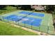Aerial view of the community tennis courts, enclosed with fencing and surrounded by mature trees at 8356 Meadow Lakes Dr, Charlotte, NC 28210
