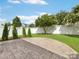 Landscaped backyard featuring a stamped concrete patio and lush green grass, perfect for entertaining at 8603 Robinson Meadow Ct, Charlotte, NC 28277