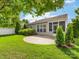 Well-manicured backyard with a stone patio, privacy fence, and a covered screened in porch at 8603 Robinson Meadow Ct, Charlotte, NC 28277