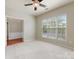 Cozy bedroom featuring plush carpeting, large windows, and plenty of natural light at 8603 Robinson Meadow Ct, Charlotte, NC 28277