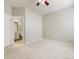 Bedroom featuring a ceiling fan, carpet and an ensuite bathroom at 8603 Robinson Meadow Ct, Charlotte, NC 28277