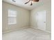 The bedroom has neutral walls, carpet, a ceiling fan and a single window with blinds at 8603 Robinson Meadow Ct, Charlotte, NC 28277