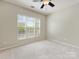 Bright bedroom with natural light, neutral walls, and ceiling fan at 8603 Robinson Meadow Ct, Charlotte, NC 28277