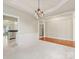 Elegant dining room featuring hardwood floors, wainscoting, and a modern chandelier at 8603 Robinson Meadow Ct, Charlotte, NC 28277