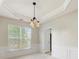 Dining area with a decorative light fixture, wainscoting, and large windows at 8603 Robinson Meadow Ct, Charlotte, NC 28277