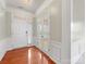 Inviting foyer featuring hardwood floors, classic wainscoting, and natural light at 8603 Robinson Meadow Ct, Charlotte, NC 28277