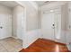 Bright foyer with hardwood floors, white wainscoting, and a view of the second doorway at 8603 Robinson Meadow Ct, Charlotte, NC 28277