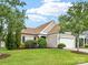 Eye-catching exterior with lush yard, pretty landscaping, and stone accents offers inviting curb appeal at 8603 Robinson Meadow Ct, Charlotte, NC 28277