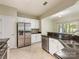 Spacious kitchen with stainless steel appliances, dark countertops, and white cabinetry at 8603 Robinson Meadow Ct, Charlotte, NC 28277