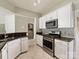 Kitchen featuring stainless appliances, white cabinets, and granite countertops at 8603 Robinson Meadow Ct, Charlotte, NC 28277