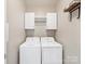 Functional laundry room equipped with a washer, dryer, and storage cabinets at 8603 Robinson Meadow Ct, Charlotte, NC 28277