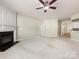 Open living room featuring a fireplace and access to the kitchen area at 8603 Robinson Meadow Ct, Charlotte, NC 28277