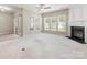 Bright living room with a fireplace, multiple windows, and a ceiling fan at 8603 Robinson Meadow Ct, Charlotte, NC 28277