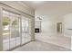View from tile floor looking into a living room with fireplace and sliding glass door at 8603 Robinson Meadow Ct, Charlotte, NC 28277