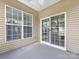 Back patio with sliding glass door and large windows that allow tons of natural light into the home at 8603 Robinson Meadow Ct, Charlotte, NC 28277