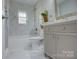 Beautiful bathroom featuring marble style tile, tub with shower, and vanity at 8607 Larchmont Cir, Charlotte, NC 28214