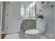 Elegant bathroom with white marble floors and vanity, well-lit with natural light at 8607 Larchmont Cir, Charlotte, NC 28214