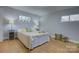 Cozy bedroom featuring hardwood floors, natural light, and neutral decor at 8607 Larchmont Cir, Charlotte, NC 28214