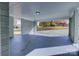 A look into the connected carport with gray painted floor and brick columns at 8607 Larchmont Cir, Charlotte, NC 28214