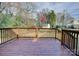 Stained wooden deck overlooking the backyard surrounded by mature trees at 8607 Larchmont Cir, Charlotte, NC 28214