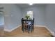 Cozy dining nook features a small table set, hardwood floors, and natural lighting at 8607 Larchmont Cir, Charlotte, NC 28214
