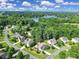 Aerial view of a beautiful home in a lush community near a serene lake and mountains at 909 Autumn Glen Ct, Lake Wylie, SC 29710