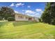 Wide shot of a backyard with a well-maintained lawn and lush green trees at 909 Autumn Glen Ct, Lake Wylie, SC 29710