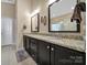 Bathroom featuring dual sinks, granite counters, framed mirrors, and tile flooring at 909 Autumn Glen Ct, Lake Wylie, SC 29710