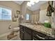 Bathroom featuring a granite countertop, modern fixtures, and a framed mirror at 909 Autumn Glen Ct, Lake Wylie, SC 29710