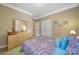 Bedroom with patterned bedding, a dresser, and a closet with double doors at 909 Autumn Glen Ct, Lake Wylie, SC 29710