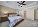 Bright bedroom featuring a tray ceiling, ceiling fan, ensuite bath, and neutral decor at 909 Autumn Glen Ct, Lake Wylie, SC 29710