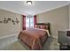 Bedroom featuring neutral walls, red accents, and large windows providing natural light at 909 Autumn Glen Ct, Lake Wylie, SC 29710