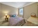 Comfortable bedroom with patterned bedding, side tables, and natural light from a window at 909 Autumn Glen Ct, Lake Wylie, SC 29710
