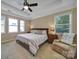 Serene bedroom with tray ceilings and ample natural light from the surrounding windows at 909 Autumn Glen Ct, Lake Wylie, SC 29710