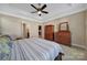 Bedroom featuring a ceiling fan, ensuite bath access, and two wooden dressers at 909 Autumn Glen Ct, Lake Wylie, SC 29710