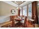 Elegant dining room featuring tray ceilings, wainscoting, and a chandelier over a round table at 909 Autumn Glen Ct, Lake Wylie, SC 29710