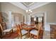 Bright dining room with tray ceilings, decorative columns, and an open view into the living room at 909 Autumn Glen Ct, Lake Wylie, SC 29710