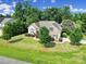 Aerial view of a charming home with a stone facade, green shutters, and a well-manicured lawn at 909 Autumn Glen Ct, Lake Wylie, SC 29710