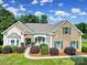 Beautiful home exterior featuring stone accents, green shutters, and landscaped greenery at 909 Autumn Glen Ct, Lake Wylie, SC 29710