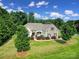 An elevated view of a beautiful home with a well-maintained lawn and mature trees at 909 Autumn Glen Ct, Lake Wylie, SC 29710