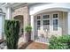 Charming front porch featuring stone accents, columns, and outdoor seating with a table at 909 Autumn Glen Ct, Lake Wylie, SC 29710