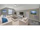 Cozy living room featuring modern furniture, a large television, and bright decor at 909 Autumn Glen Ct, Lake Wylie, SC 29710